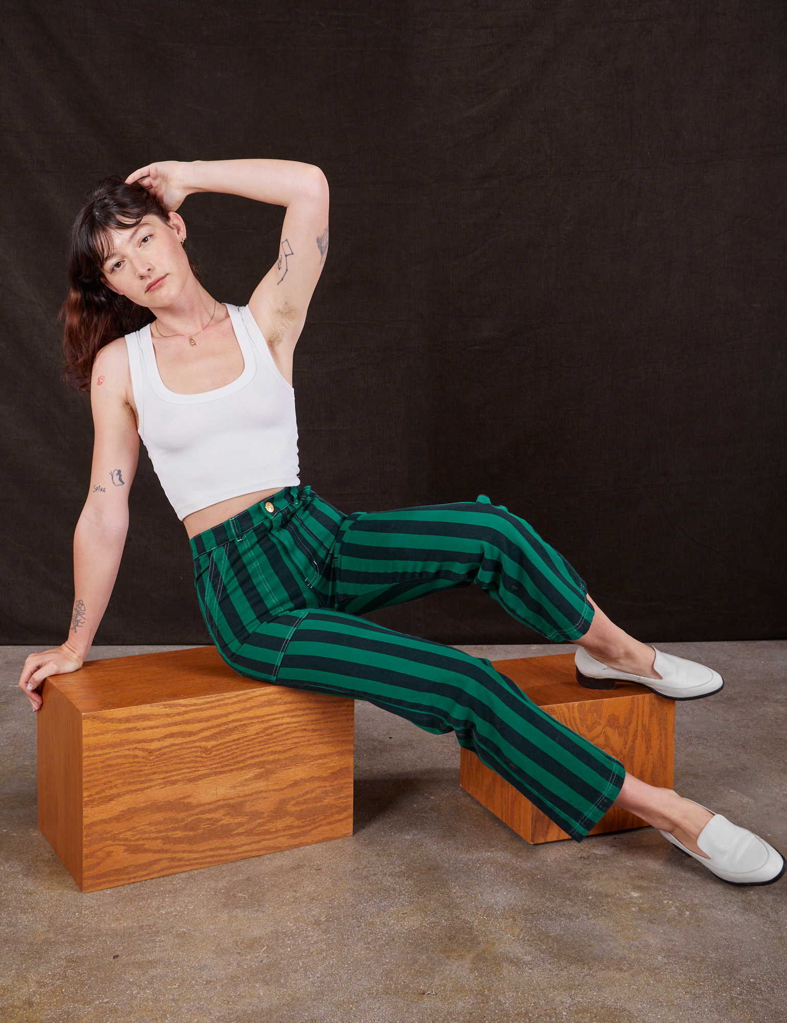 Alex is wearing Black Stripe Work Pants in Hunter and vintage off-white Cropped Tank Top
