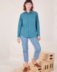 Alex is wearing a buttoned up Oversize Overshirt in Marine Blue paired with light wash Frontier Jeans