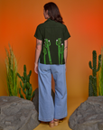 Back view of Paintstamped Pantry Button-Up in Cactus and light wash Indigo Wide Leg Trousers
