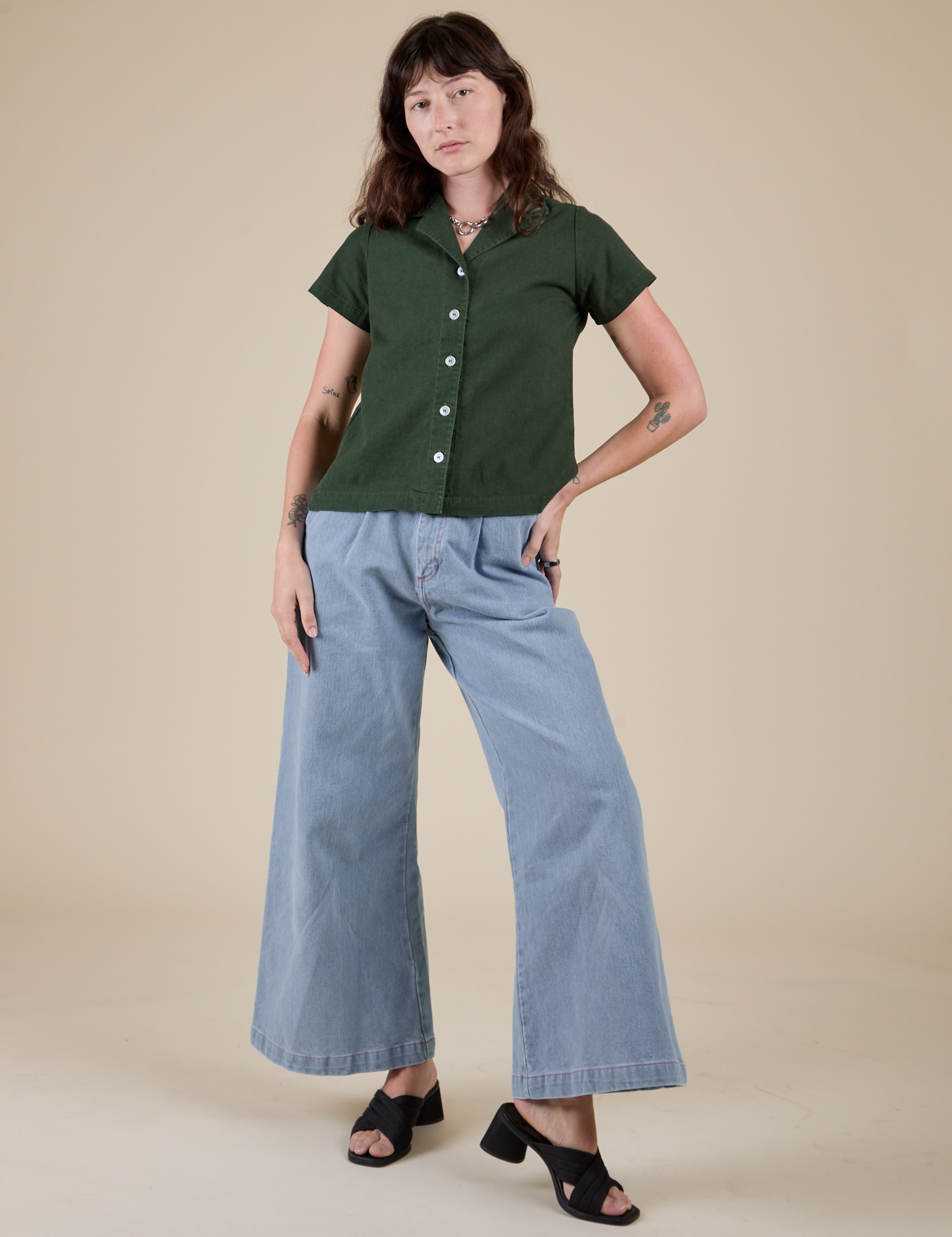 Alex is wearing Pantry Button-Up in Swamp Green and light wash Indigo Wide Leg Trousers