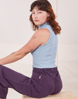Angled back view of Sleeveless Essential Turtleneck in Periwinkle and nebula purple Bell Bottoms on Alex