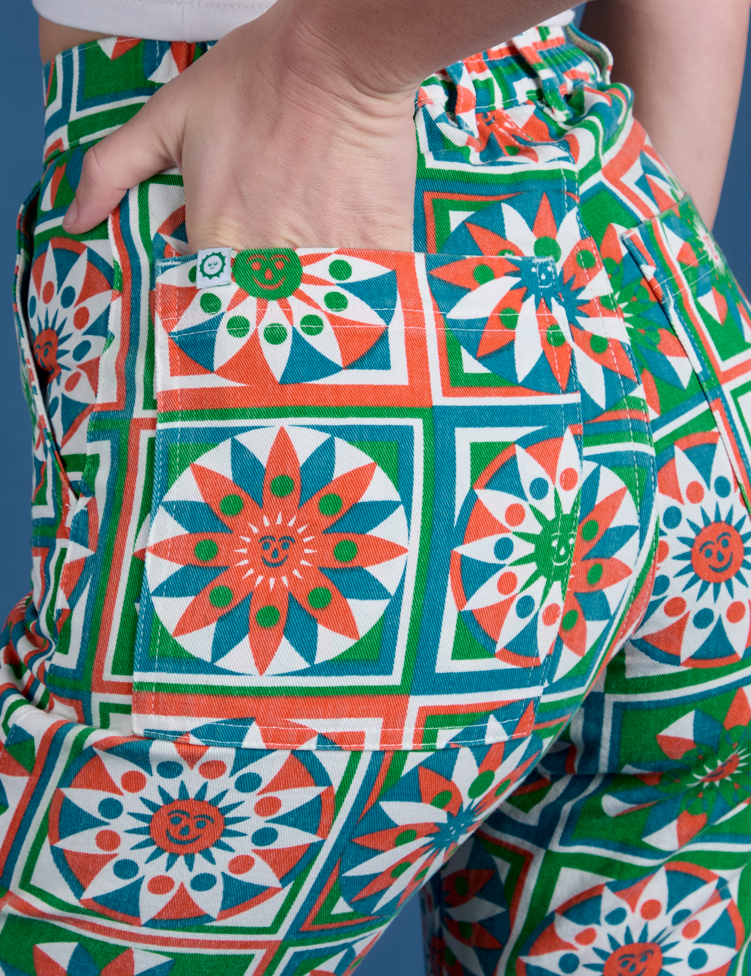 Close up of Alex&#39;s hand in the back pocket of Work Pants in Quilt Print