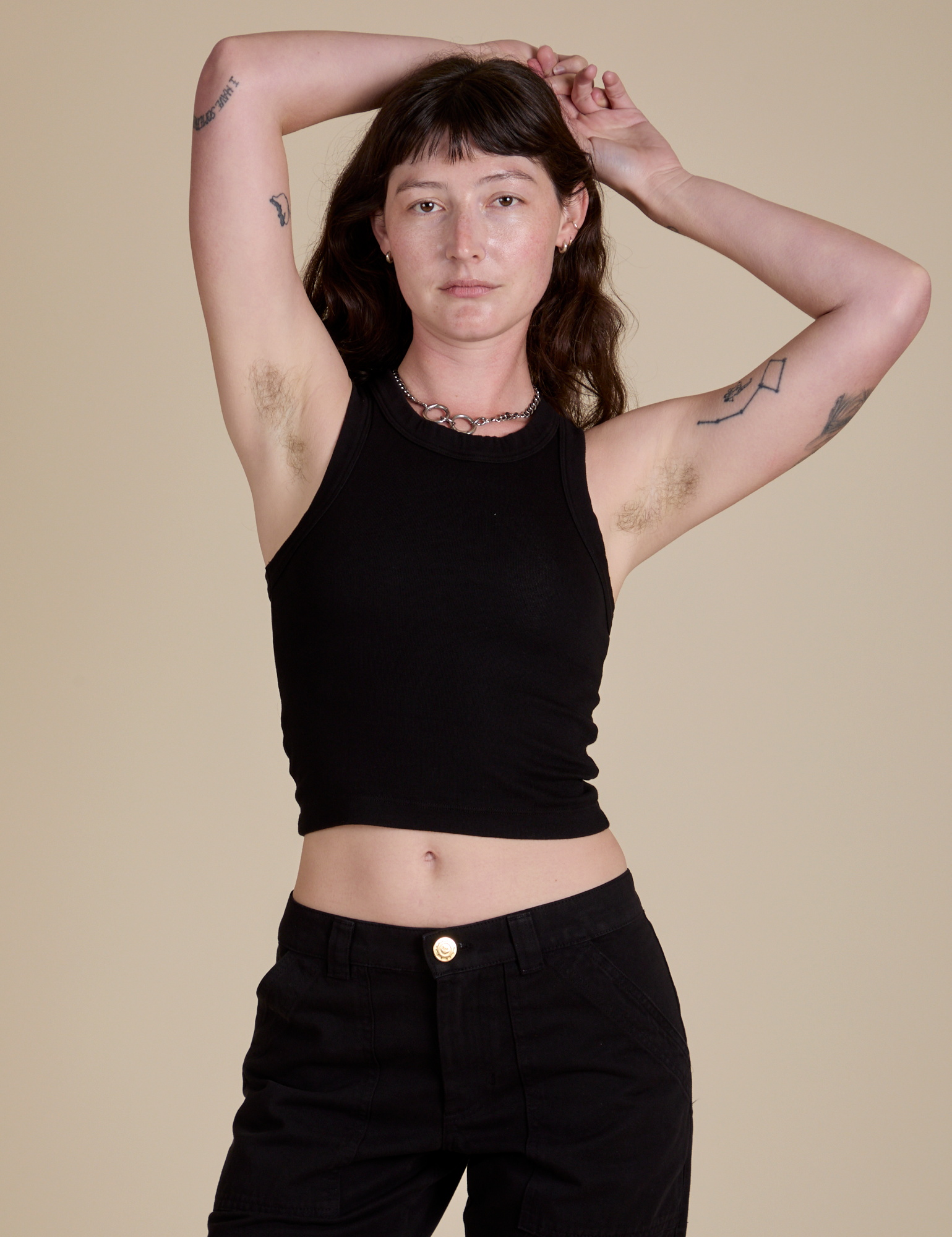 Alex is 5’8” and wearing P Racerback Tank in Black