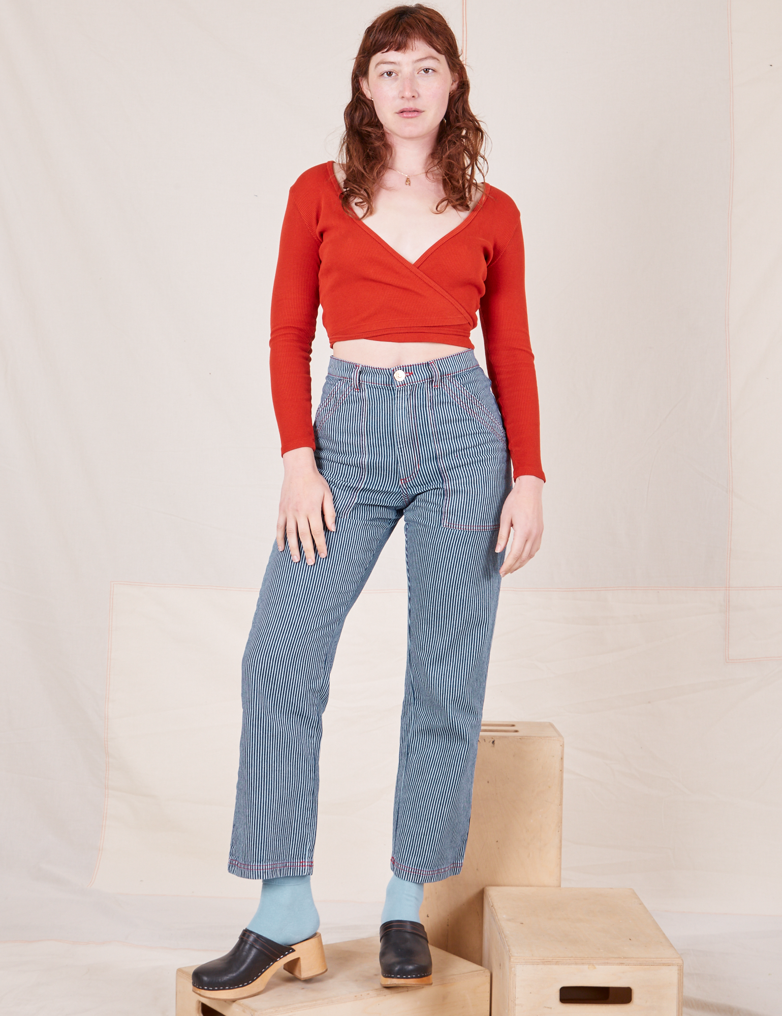 Alex is 5&#39;8&quot; and wearing XS Railroad Stripe Denim Work Pants paired with a paprika Long Sleeve V-Neck Tee