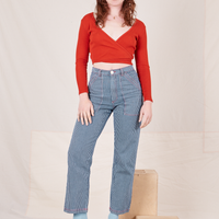 Alex is 5'8" and wearing XS Railroad Stripe Denim Work Pants paired with a paprika Long Sleeve V-Neck Tee