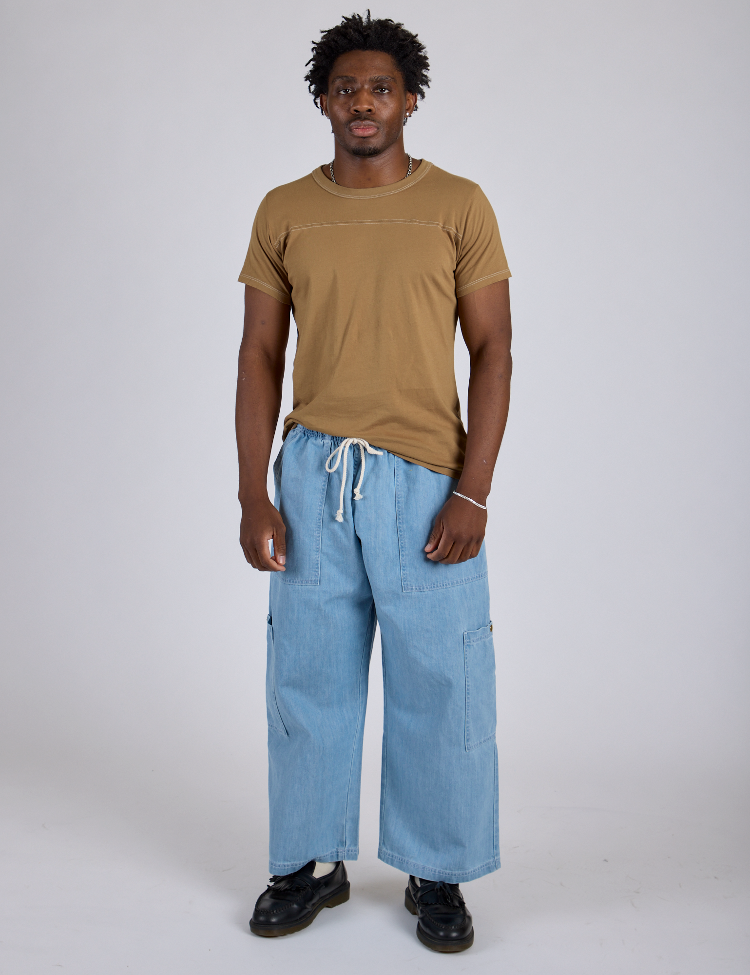 Jr. Varsity Tee in Desert Brown and light wash Denim Drop Pocket Pants on Isaac