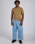 Jr. Varsity Tee in Desert Brown and light wash Denim Drop Pocket Pants on Isaac