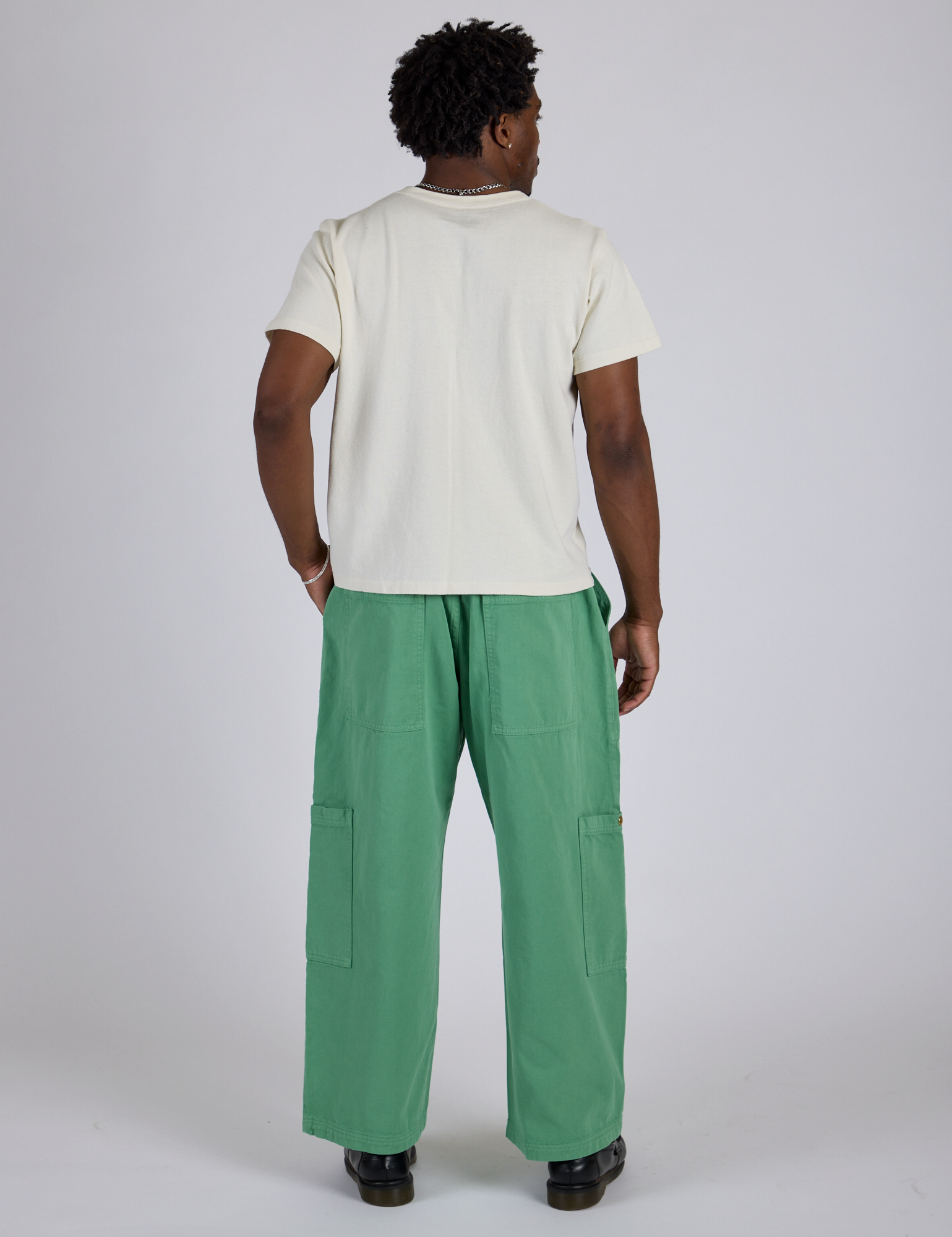 Back view of Drop Pocket Cargo Pants in Seafoam Green and Organic Vintage Tee in Vintage Tee White on Isaac