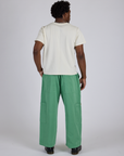 Back view of Drop Pocket Cargo Pants in Seafoam Green and Organic Vintage Tee in Vintage Tee White on Isaac