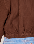 Back close up of the Ricky Jacket in Fudgesicle Brown. Elastic along the hem of the jacket.