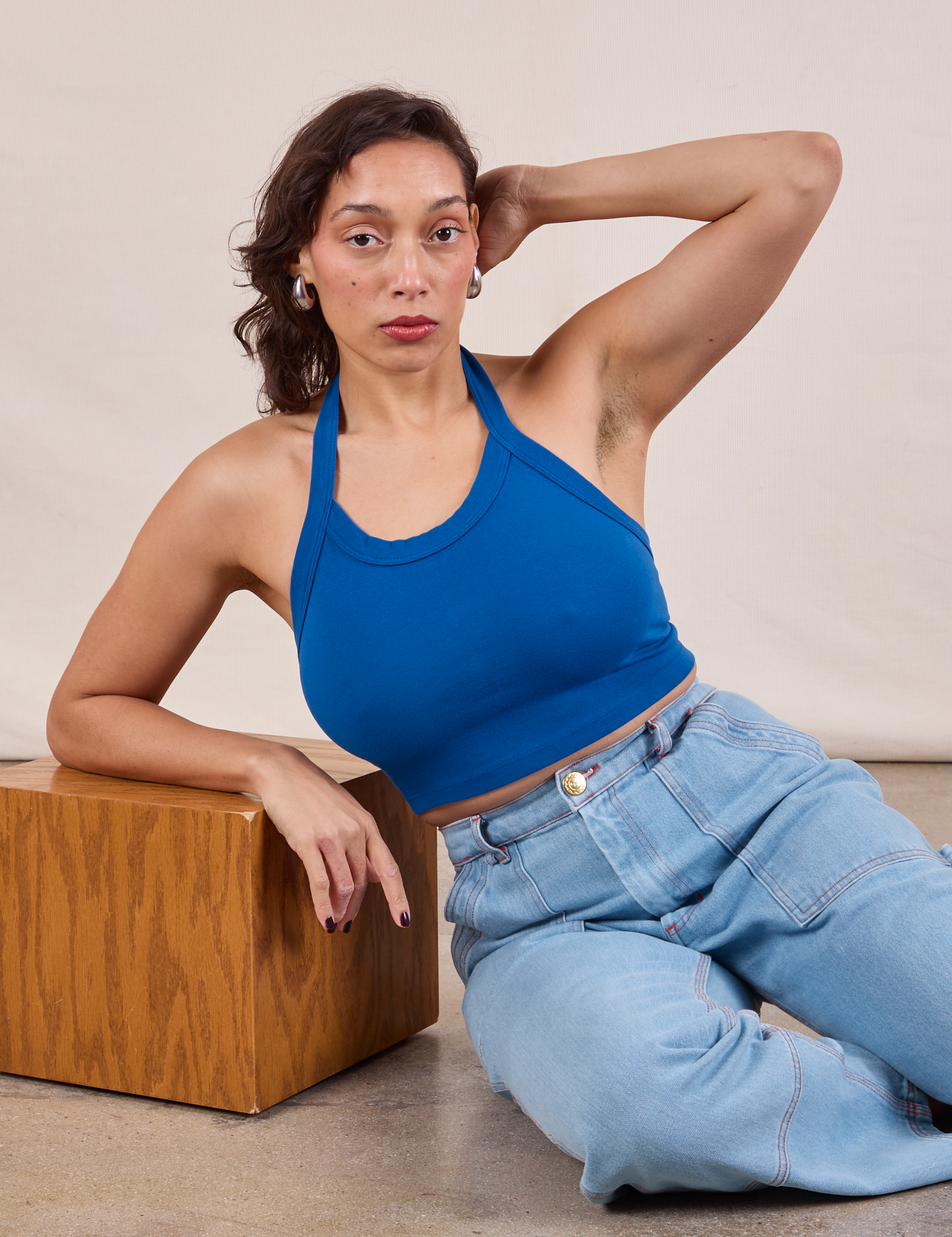 Tiara is wearing Halter Top in Royal Blue and light wash Carpenter Jeans