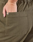 Short Sleeve Jumpsuit in Surplus Green back pocket close up on Ryan