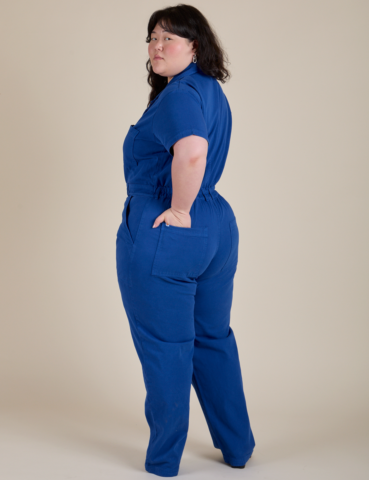 Angled back view of Short Sleeve Jumpsuit in Royal Blue on Ashley
