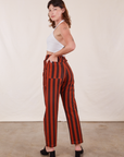 Angled back view of Black Striped Work Pants in Paprika on Alex