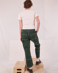 Back view of Carpenter Jeans in Swamp Green and Organic Vintage Tee in Vintage Tee Off-White on Quinn