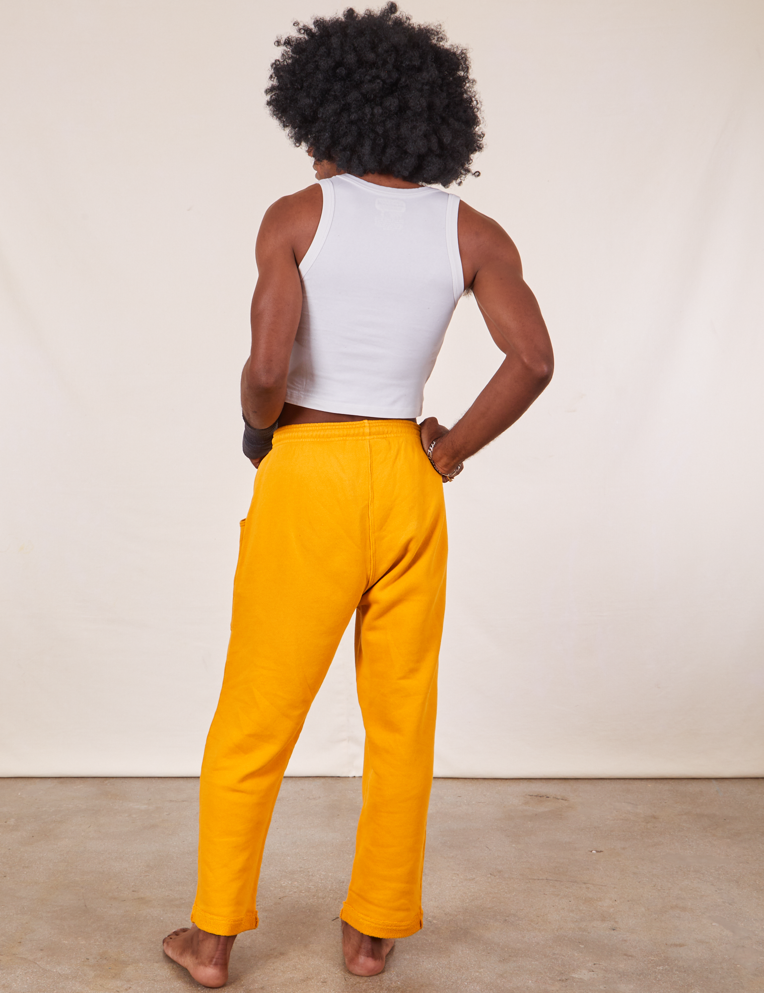 Back view of Cropped Rolled Cuff Sweatpants in Mustard Yellow on Jerrod