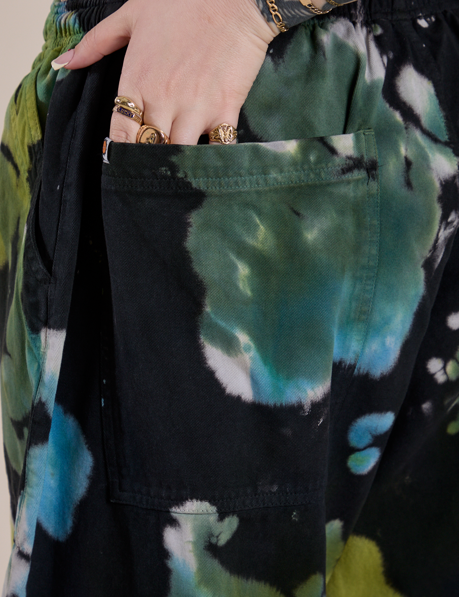 Close up of Sydney's hand in the back pocket of Magic Waters Drop Pocket Pants in Green Pool