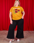 Juliet is wearing 3 Roses Organic Tee and black Bell Bottoms