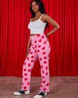 Side view of Paintstamped Heart Work Pants in Bubblegum Pink and Cami in vintage tee off-white on Kandia