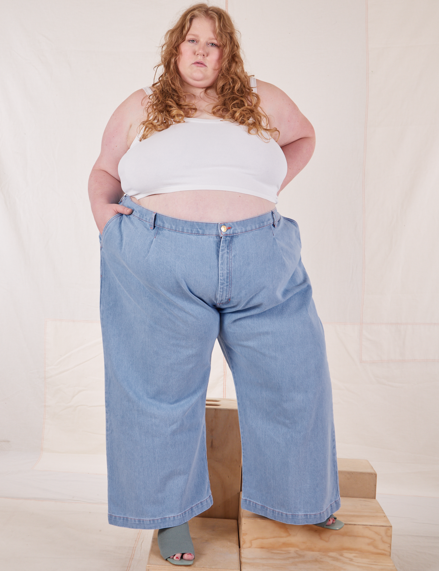 Catie is 5&#39;11&quot; and wearing 4XL Indigo Wide Leg Trousers in Light Wash paired with vintage off-white Cami