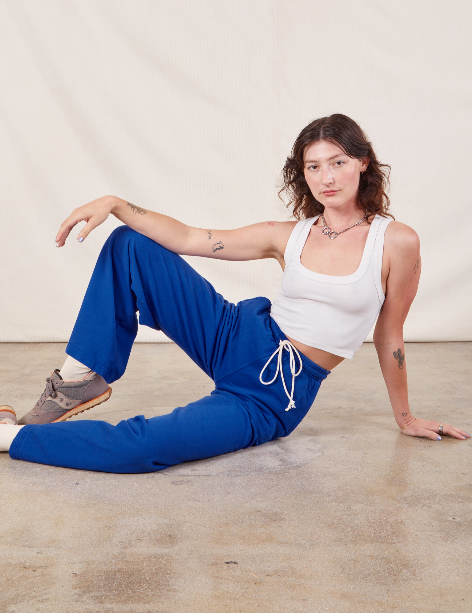 Alex is wearing Wide Leg Sweat Pants in Royal Blue and Cropped Tank in vintage tee off-white