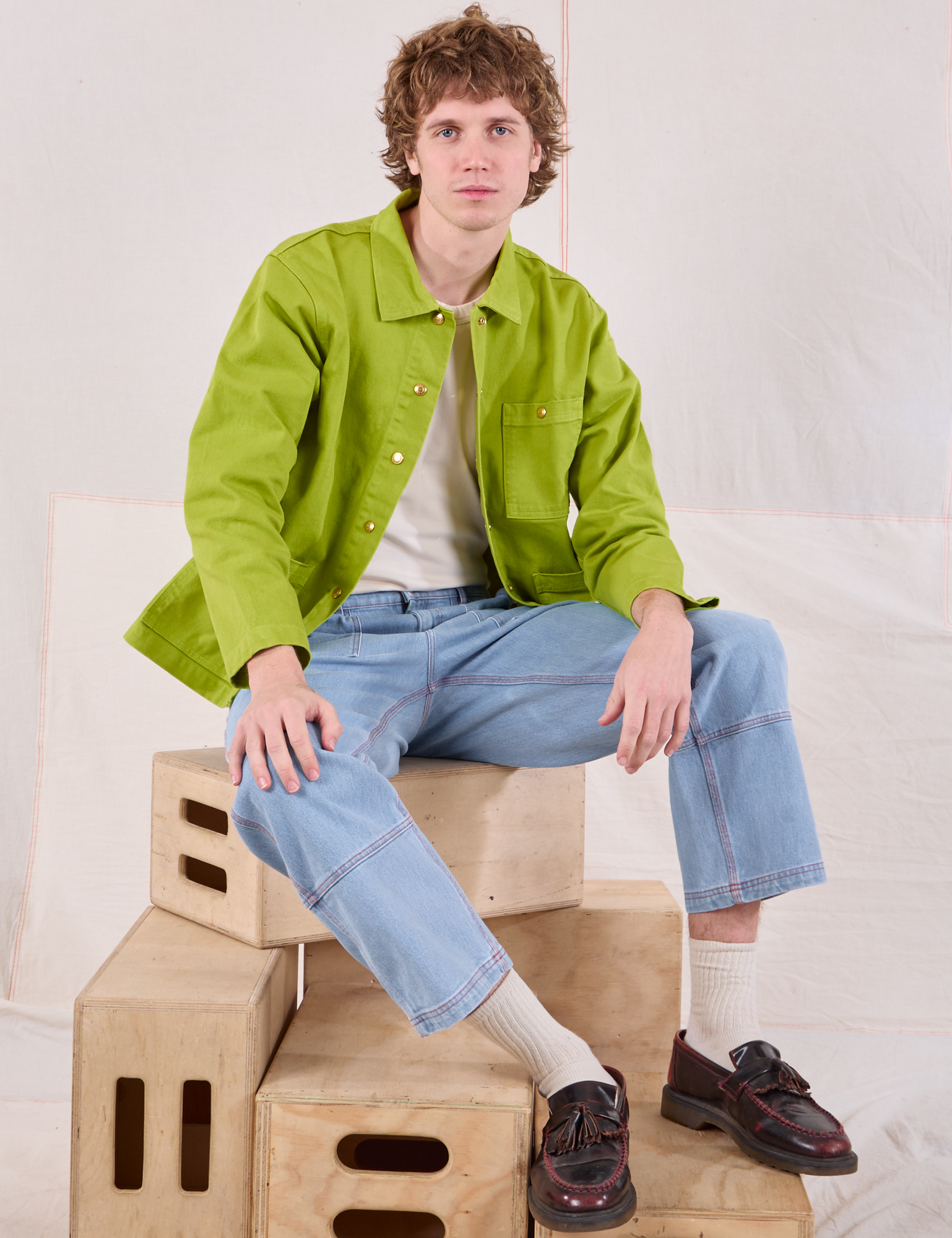 Quinn is wearing Denim Work Jacket in Gross Green and light wash Carpenter Jeans