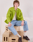 Quinn is wearing Denim Work Jacket in Gross Green and light wash Carpenter Jeans