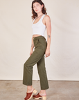 Side view of Work Pants in Surplus Green and Cropped Tank in vintage tee off-white on Alex