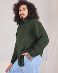 Angled front view of Flannel Overshirt in Swamp Green on Jesse