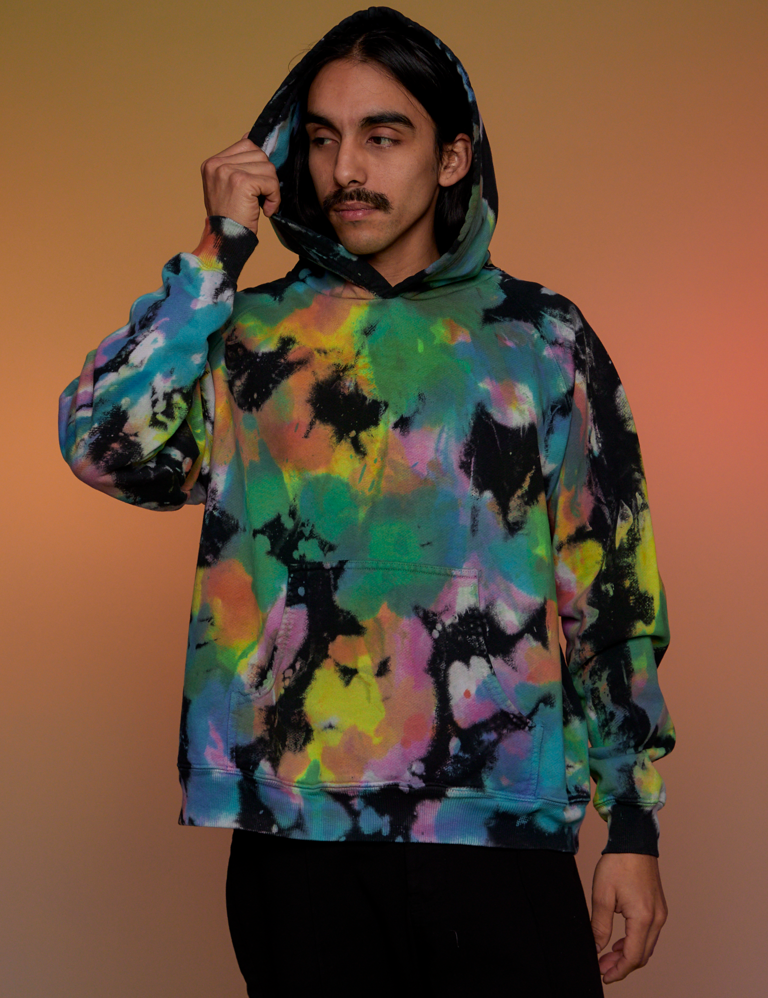 Oversized Hoodie in Rainbow Magic Waters worn on Anthony with the hood on