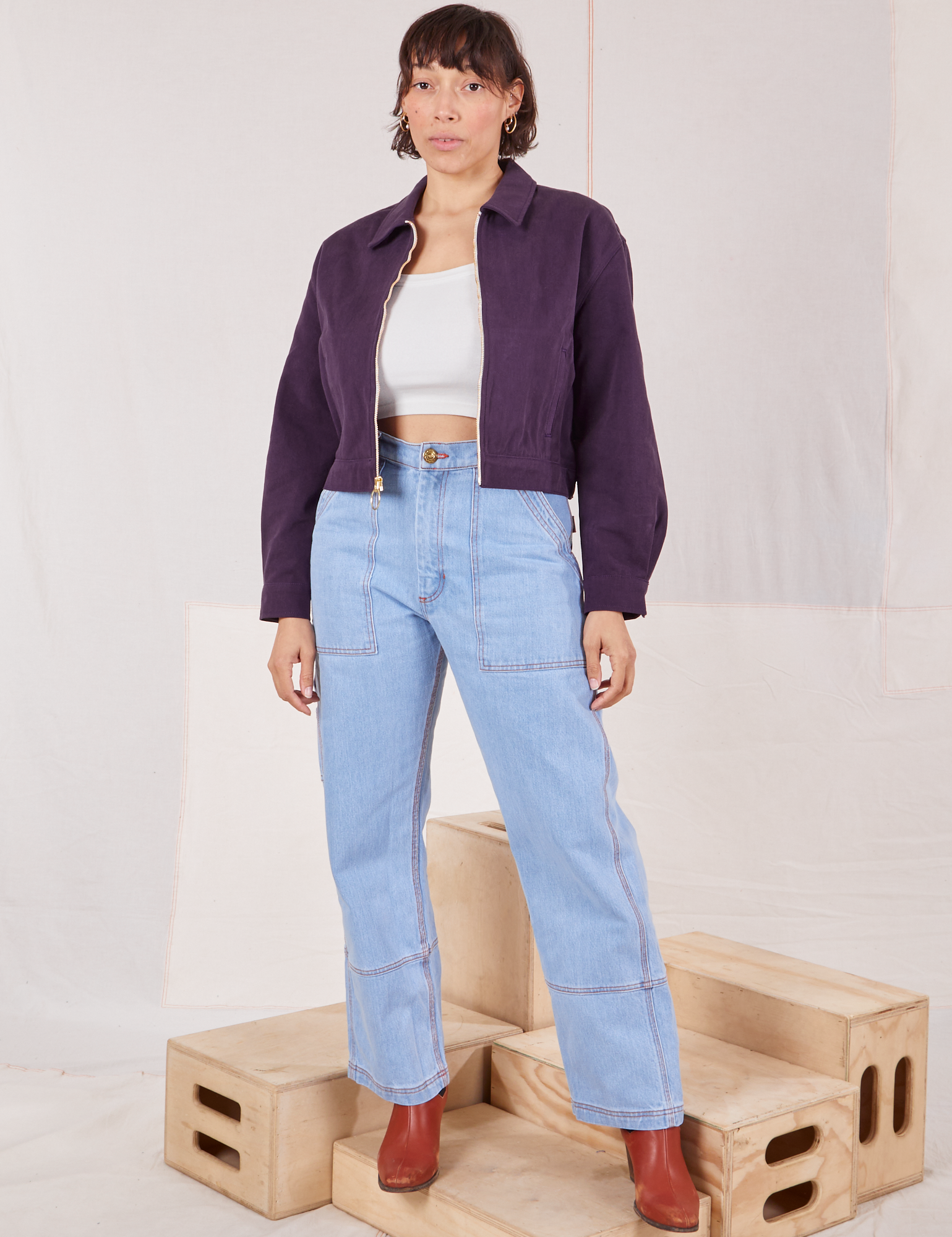 Tiara is wearing Ricky Jacket in Nebula Purple and vintage tee off-white Cami and light wash Carpenter Jeans
