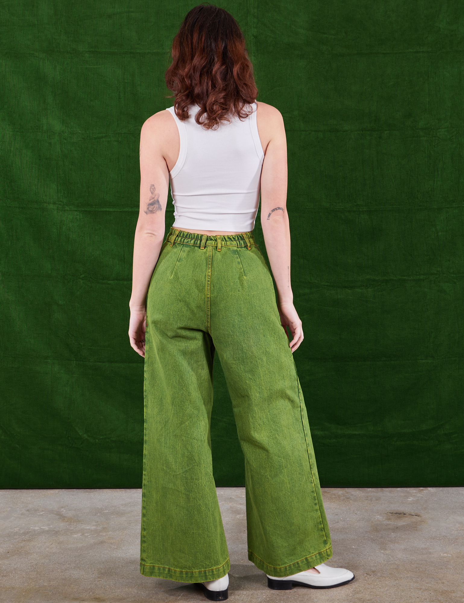 Back view of Overdyed Wide Leg Trousers in Gross Green and vintage off-white Cropped Cami on Alex