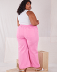 Angled back view of Action Pants in Bubblegum Pink and Tank Top in vintage tee off-white worn by Morgan