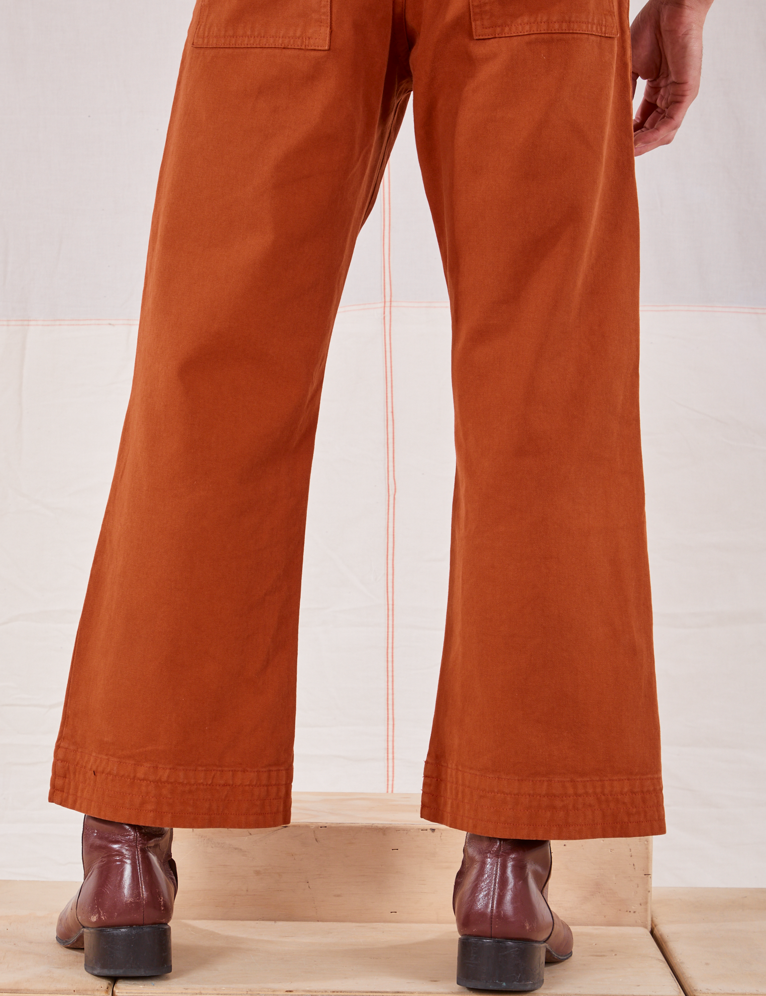 Action Pants in Burnt Terracotta back pant leg close up on Jesse