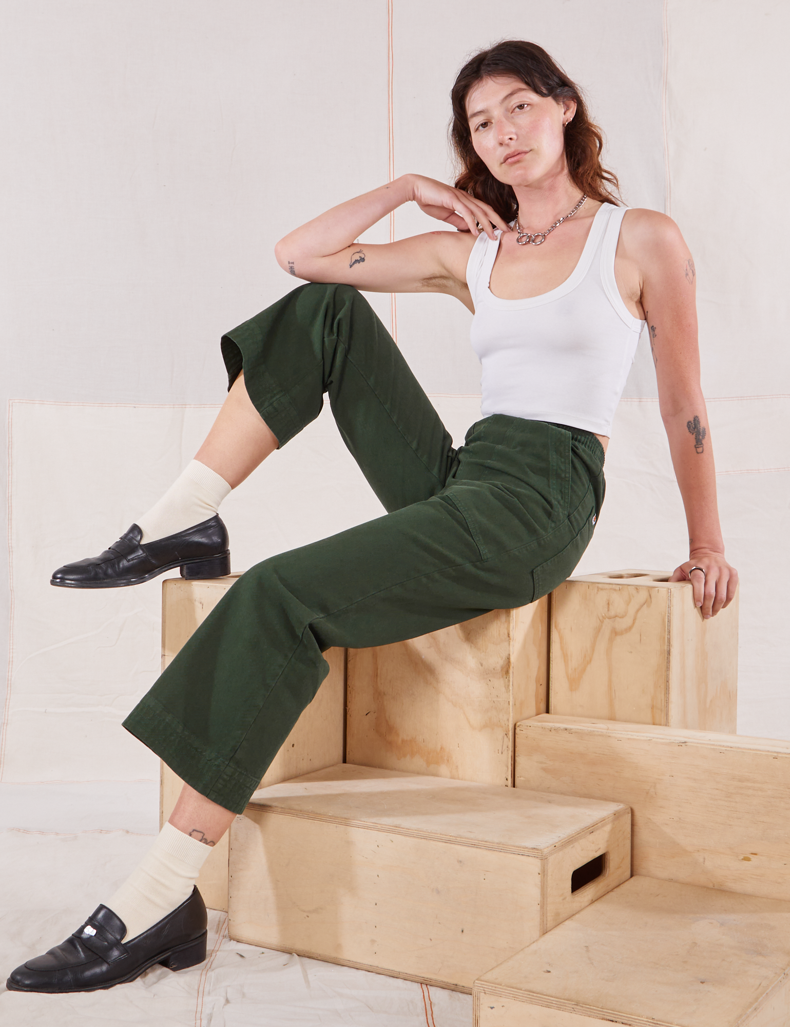 Alex is wearing Action Pants in Swamp Green and Cropped Tank in vintage tee off-white