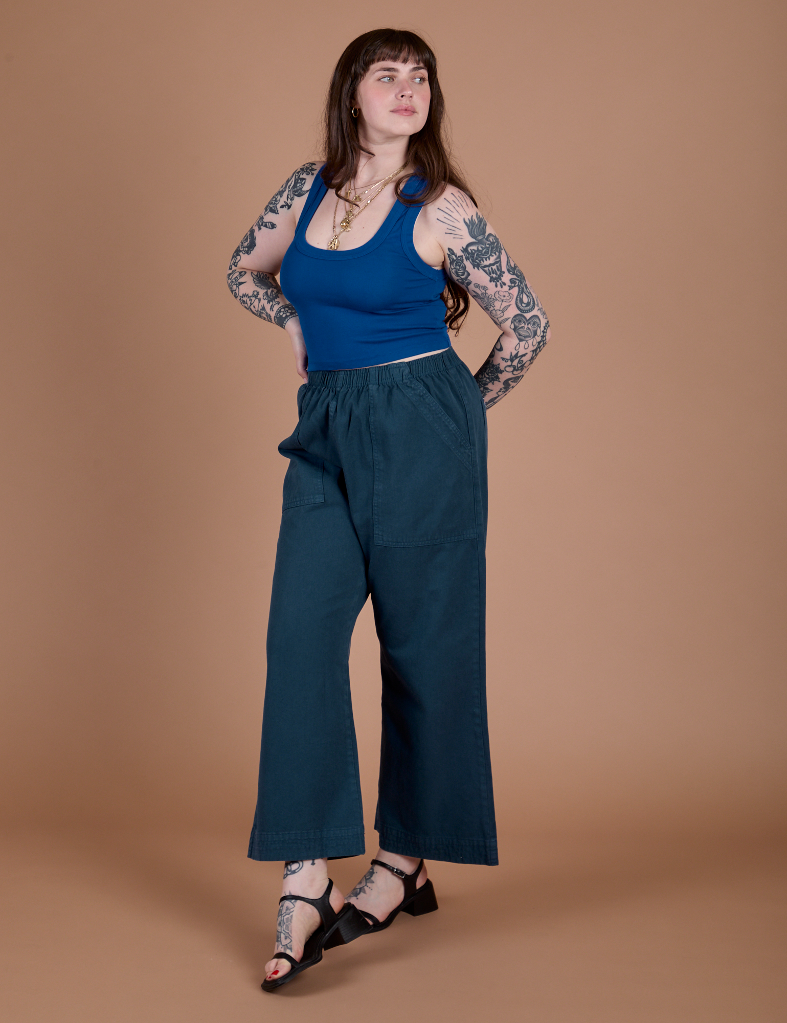 Angled front view of Action Pants in Lagoon and royal blue Cropped Tank