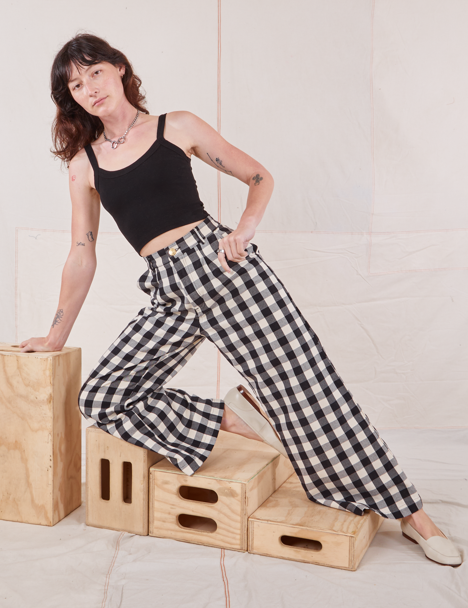 Alex is wearing Wide Leg Trousers in Big Gingham and black Cropped Cami