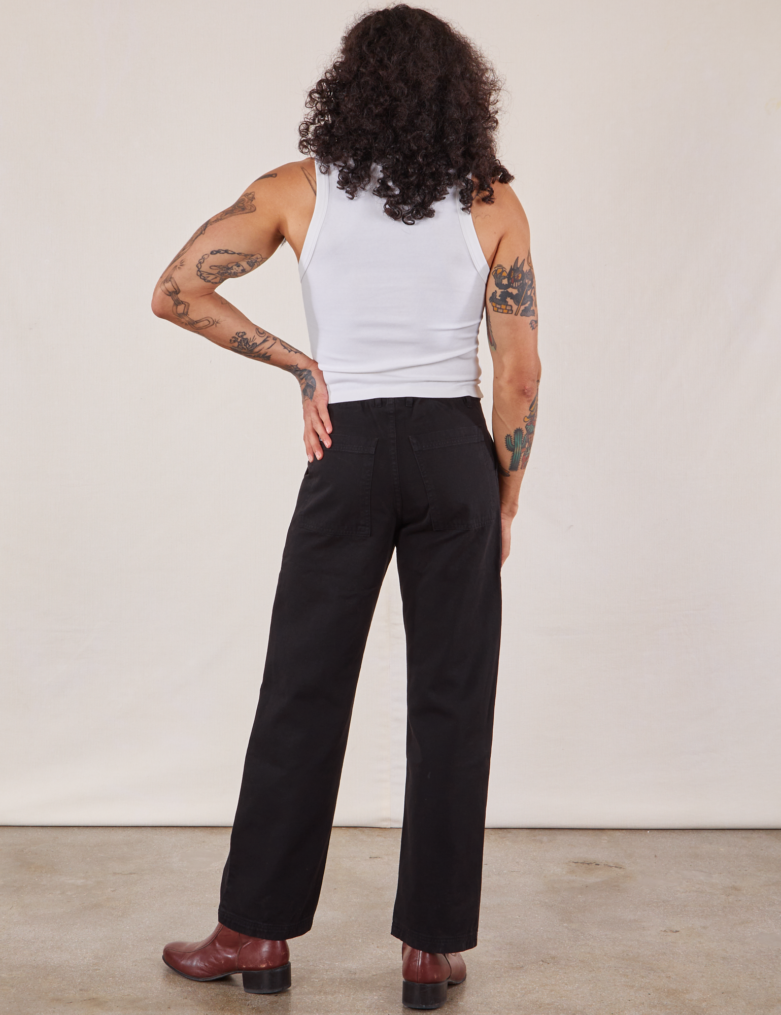 Back view of Work Pants in Black and Cropped Tank in vintage tee off-white on Jesse