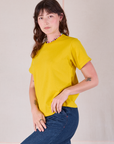 Burly Tee in Golden Yellow angled front view on Alex