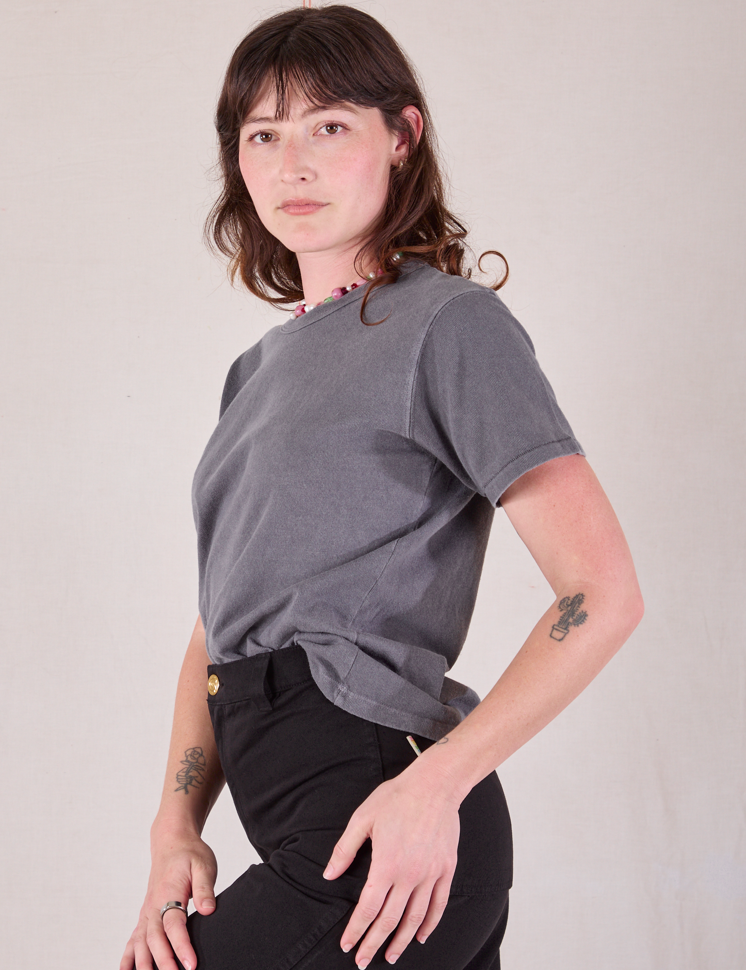 Burly Tee in Washed Grey angled front view tucked into pants on Alex