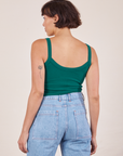 Back view of Cropped Cami in Hunter Green and light wash Sailor Jeans worn by Tiara