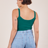Back view of Cropped Cami in Hunter Green and light wash Sailor Jeans worn by Tiara