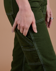 Carpenter Jeans in Evergreen pant leg side view close up on Alex