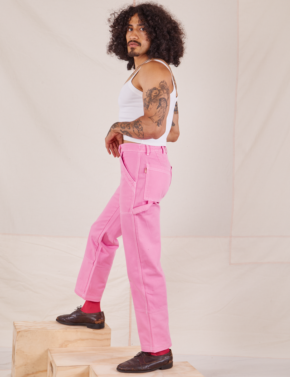 Side view of Carpenter Jeans in Bubblegum Pink worn by Jesse