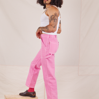 Side view of Carpenter Jeans in Bubblegum Pink worn by Jesse