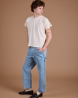 Angled front view of Carpenter Jeans in Light Wash and Organic Vintage Tee in Vintage Tee Off-White on Quinn