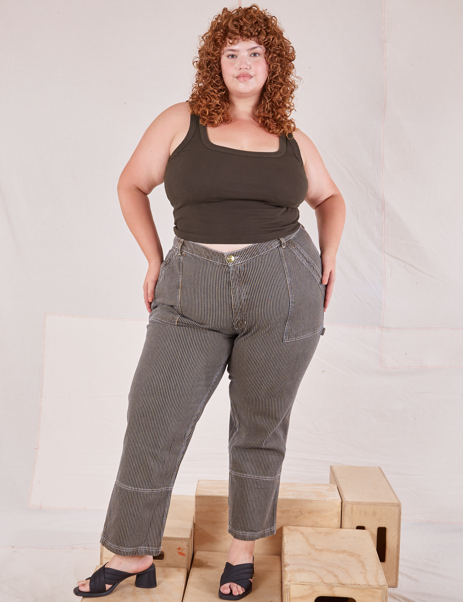 Bree is 5&#39;9&quot; and wearing 2XL Railroad Carpenter Jeans in Vintage Tan paired with espresso brown Square Neck Tank