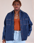 Issac is 5'10" and wearing S Denim Overshirt in Dark Wash worn with a burnt terracotta Cropped Tank underneath