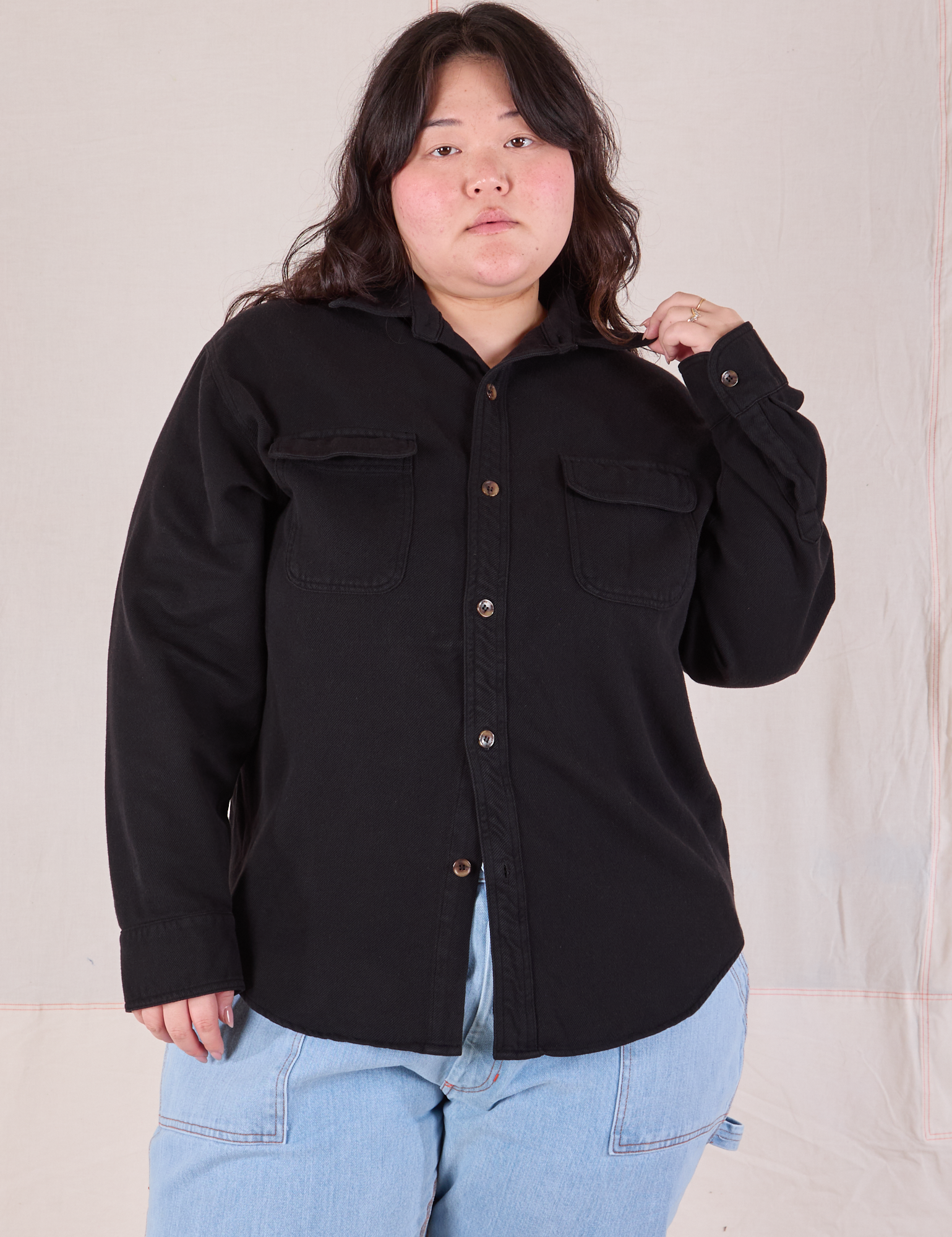 Ashley is wearing a buttoned up Flannel Overshirt in Basic Black