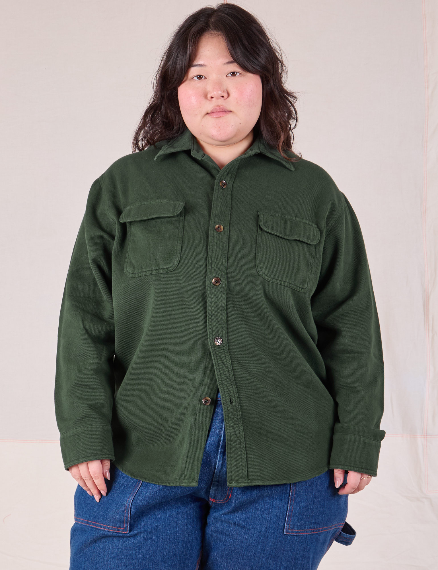 Ashley is wearing a buttoned up Flannel Overshirt in Swamp Green